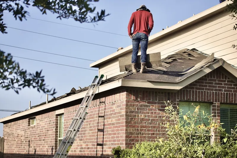 Professional roofer working on a residential roof in Douglassville